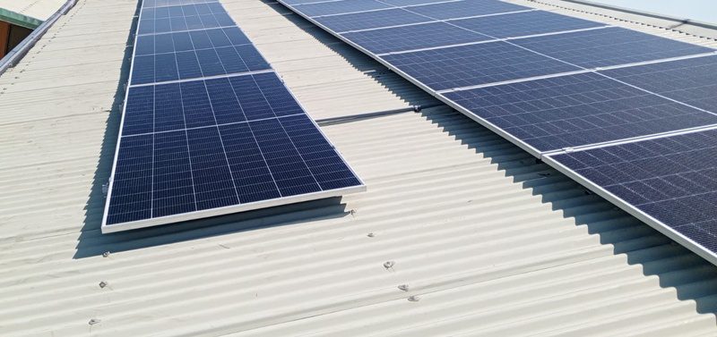 Two panel sub-arrays on a white corrugated roof.