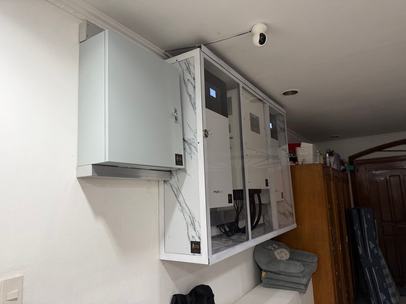 Side view of the cabinet with the small protection box mounted beside it.